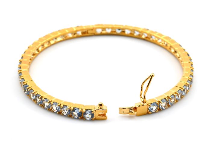 The bracelet is hard gilt, with blue zircon